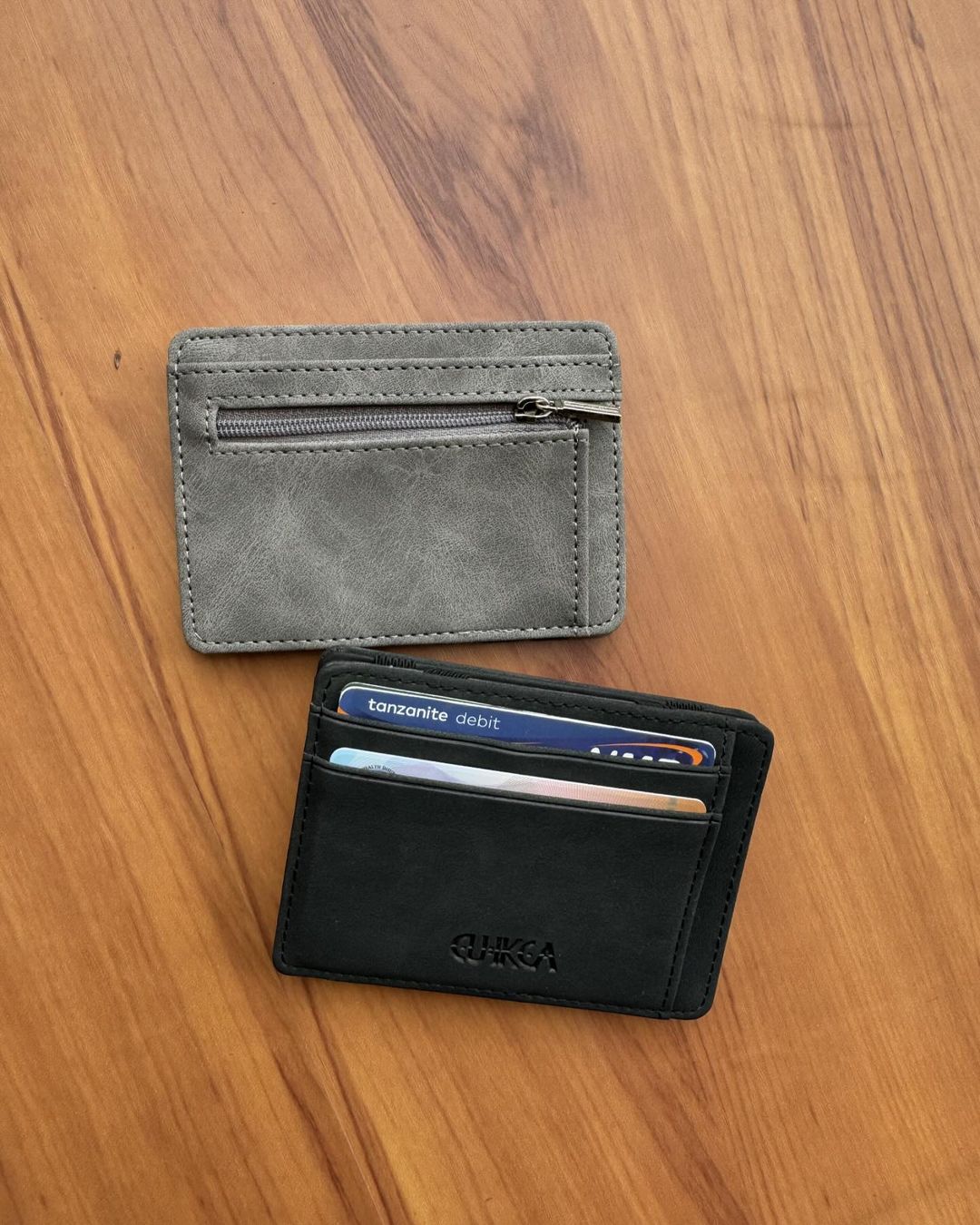 Takeer - Coin Zipper wallet available in two colours 
Black&grey 
25000/=